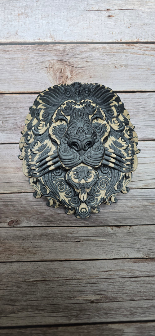 Front view of the Oathmane Guardian lion wall plaque showing its symmetrical face, flowing ornamental mane and dual-colour finish.
