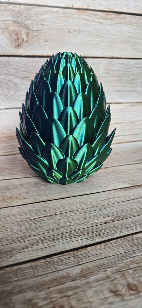 Closed iridescent dragon egg storage box with layered scales shifting between green, blue and purple.
